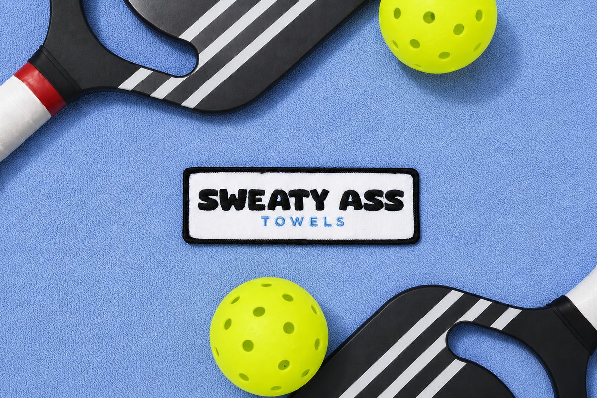 Sweaty Ass Towel in light blue, laid out on the ground